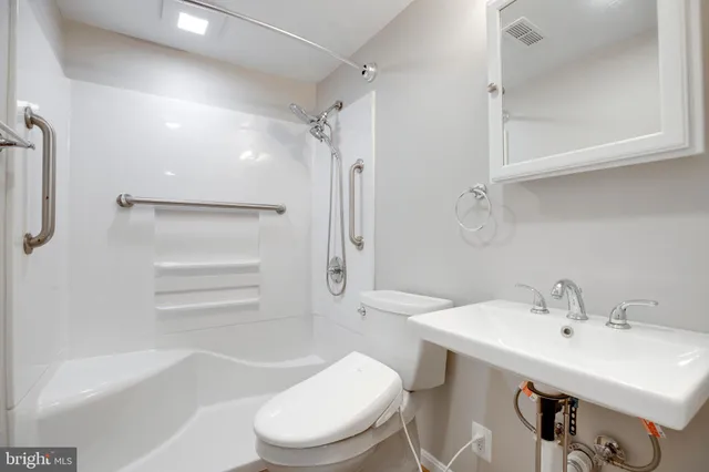 a bathroom with a sink toilet and shower