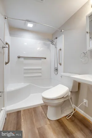 a bathroom with a toilet and a shower