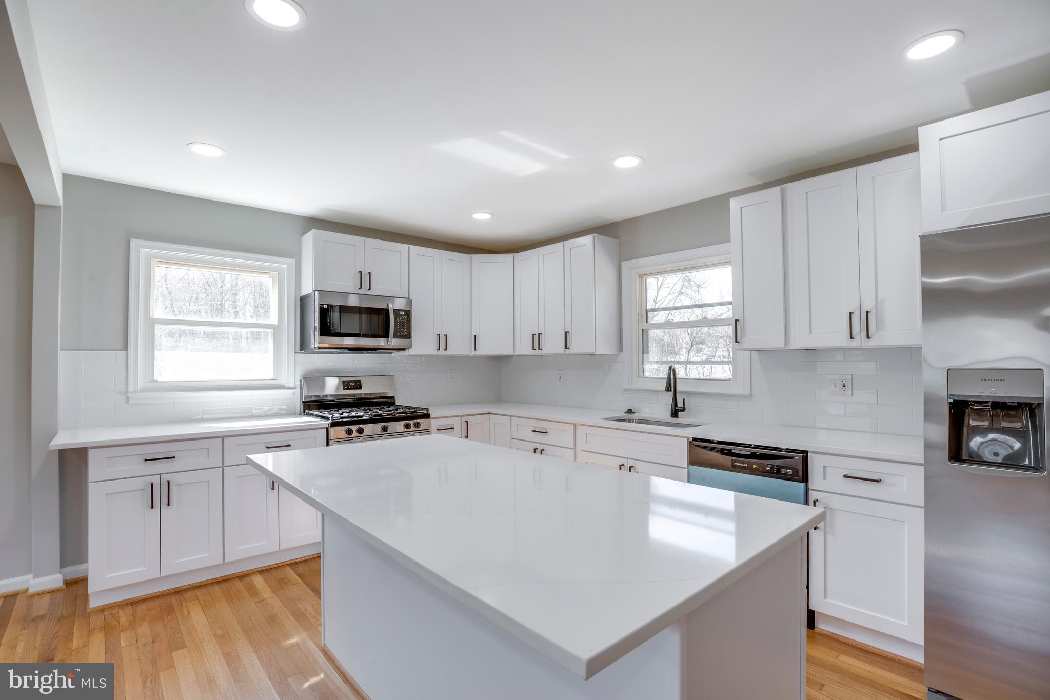4352 Granby Road Woodbridge, VA 22193 - Photo 10 of 50 a kitchen with a sink a stove a microwave and cabinets