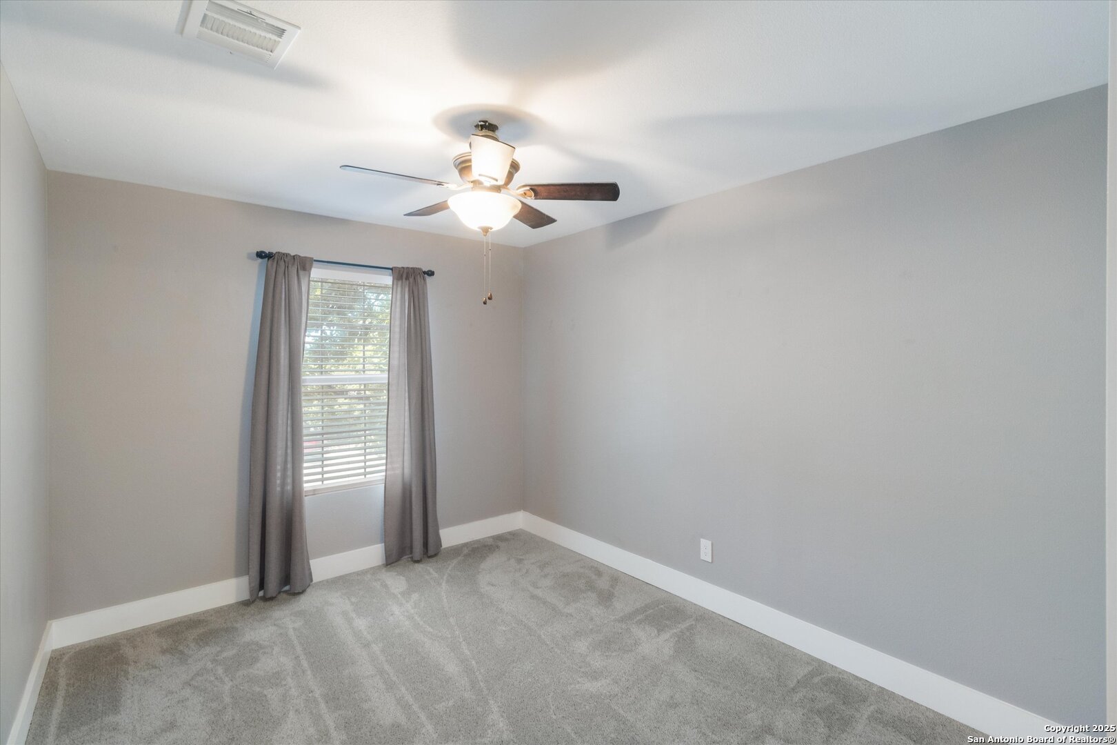 9210 Cedar Point Helotes, TX 78023 - Photo 12 of 22 an empty room with windows and ceiling fan