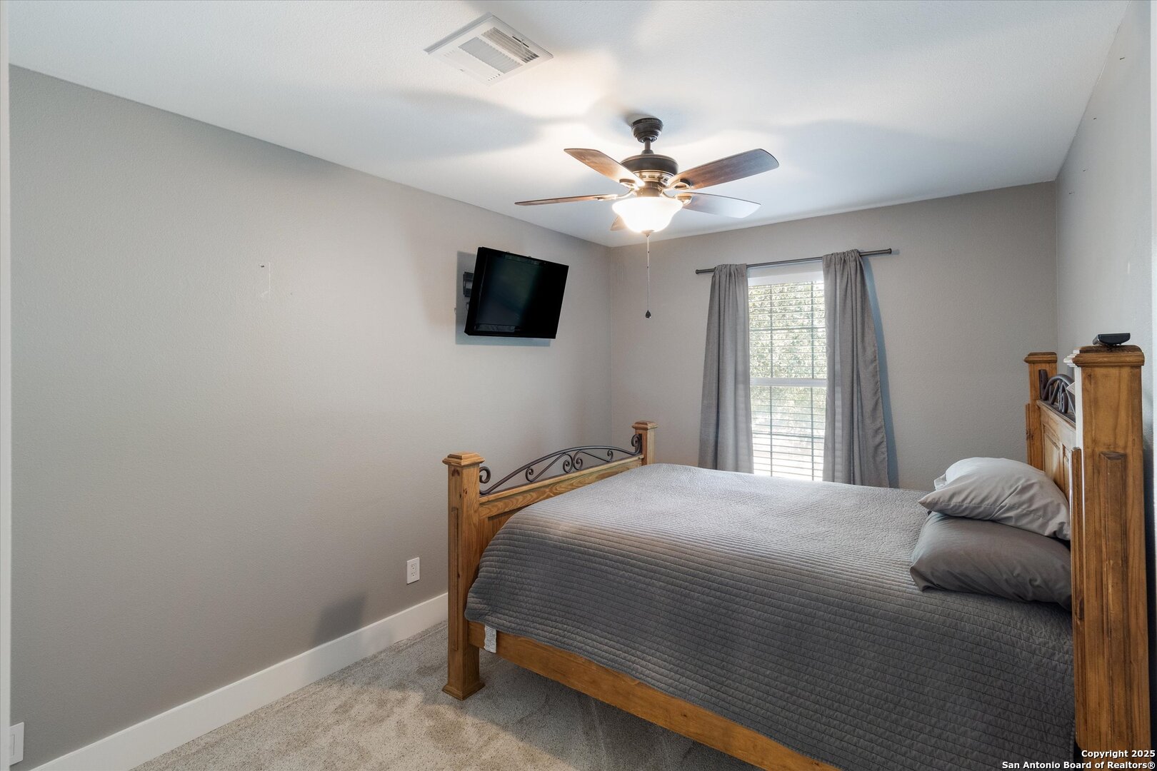 9210 Cedar Point Helotes, TX 78023 - Photo 14 of 22 a bedroom with a large bed and a window