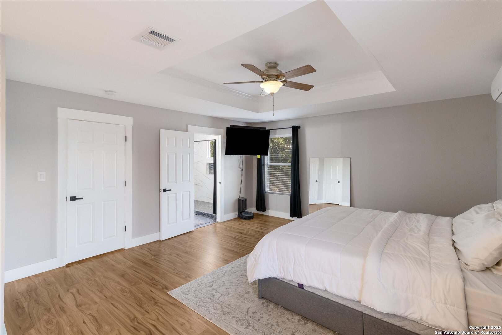 9210 Cedar Point Helotes, TX 78023 - Photo 16 of 22 a bedroom with a large bed and a chandelier