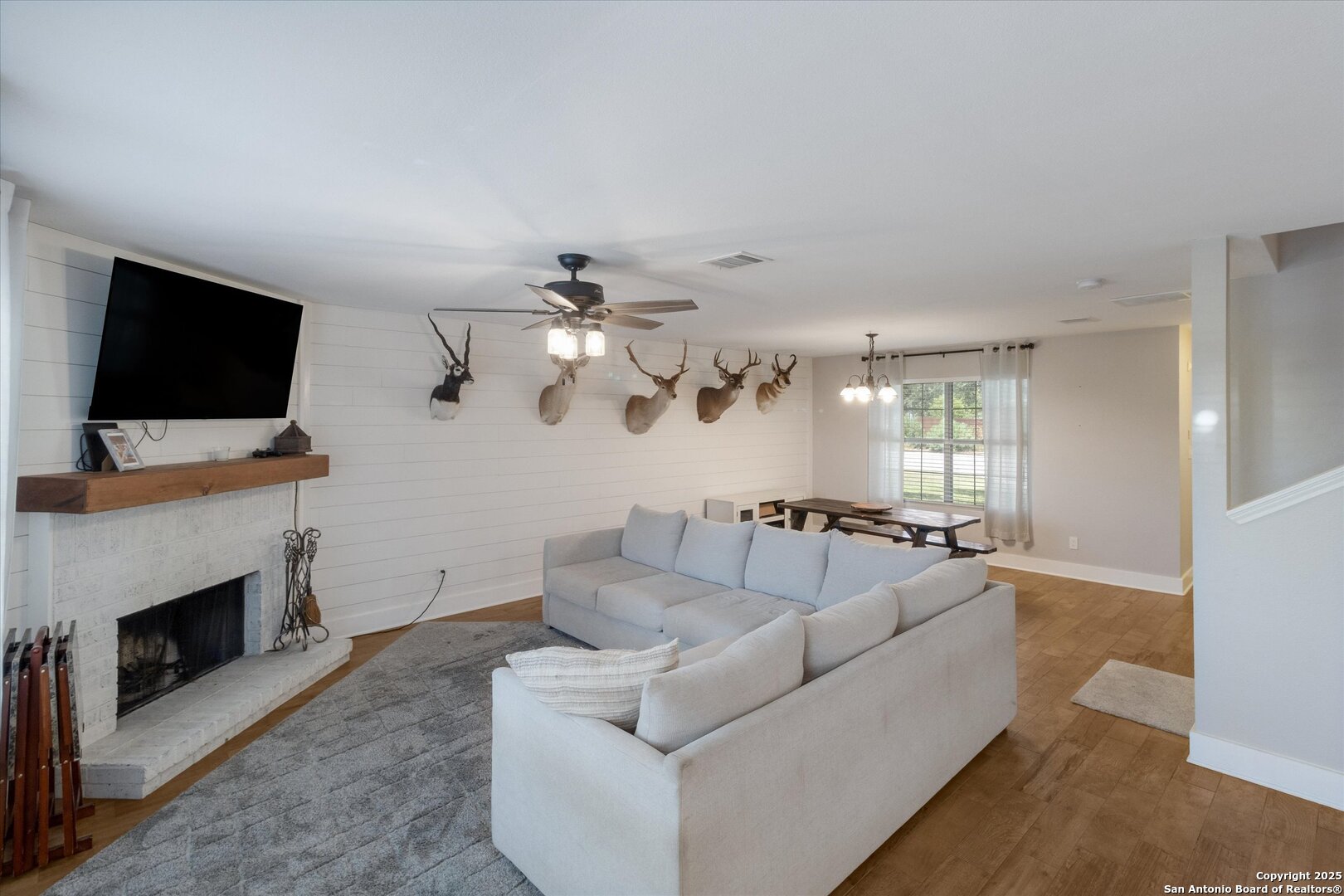 9210 Cedar Point Helotes, TX 78023 - Photo 7 of 22 a living room with furniture a fireplace and a flat screen tv