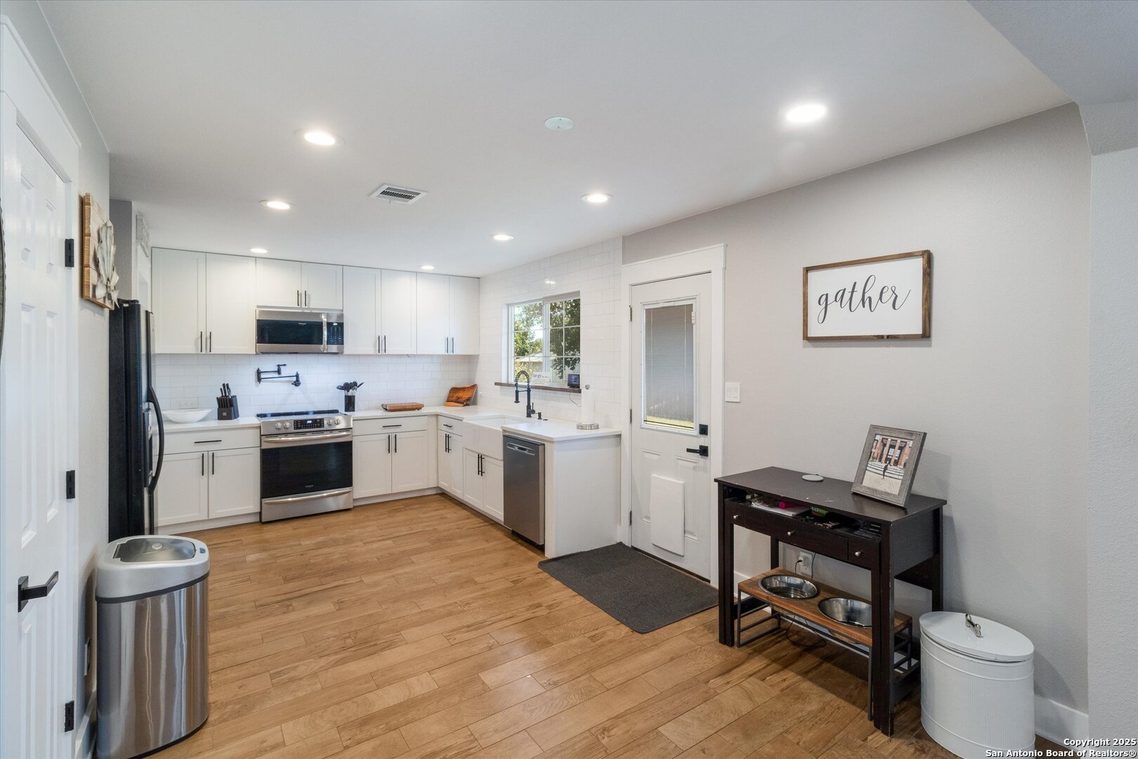 9210 Cedar Point Helotes, TX 78023 - Photo 8 of 22 a kitchen with a refrigerator a sink and a stove top oven