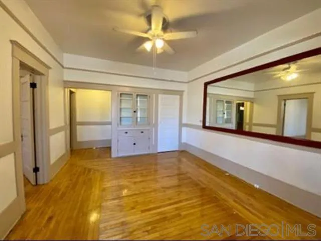 a view of a livingroom with a chandelier fan and a rug