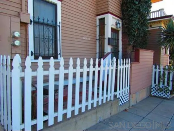 a view of a house with wooden fence