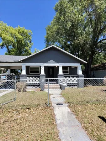 a front view of a house with a yard outdoor seating and pathway