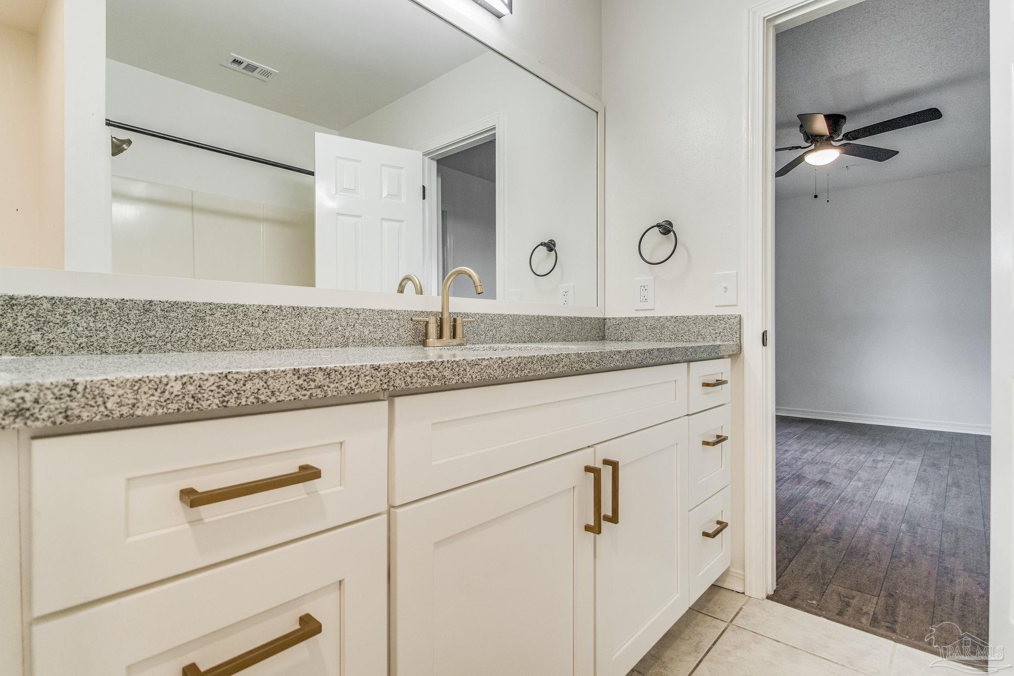 4737 Frontier Road Pace, FL 32571 - Photo 21 of 32 a bathroom with a sink and a mirror