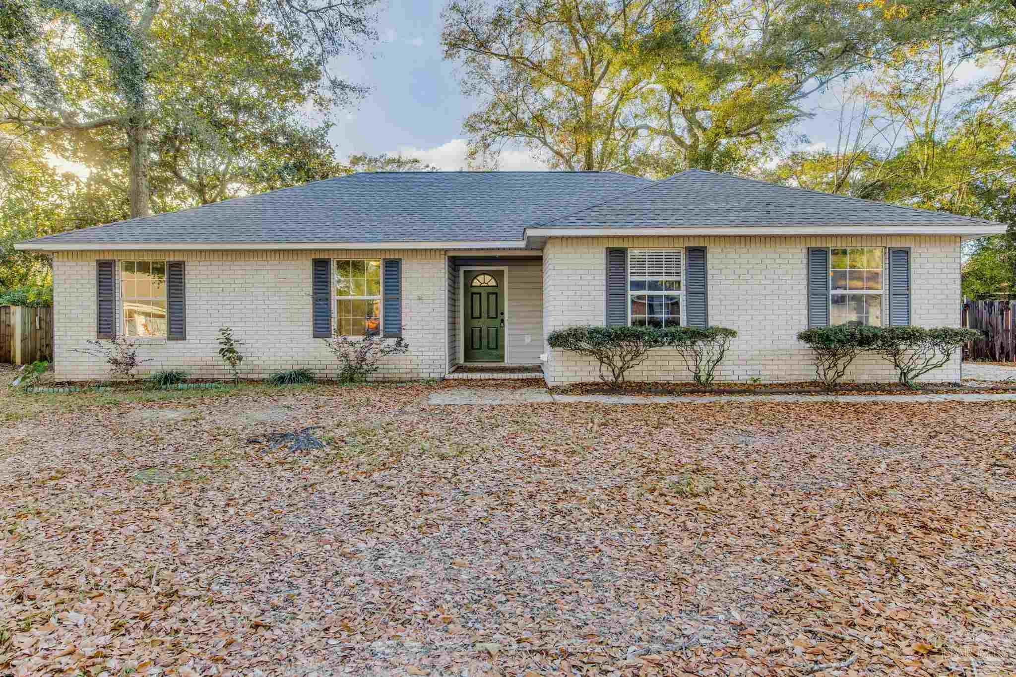 4737 Frontier Road Pace, FL 32571 - Photo 3 of 32 a view of a house with a yard and large tree