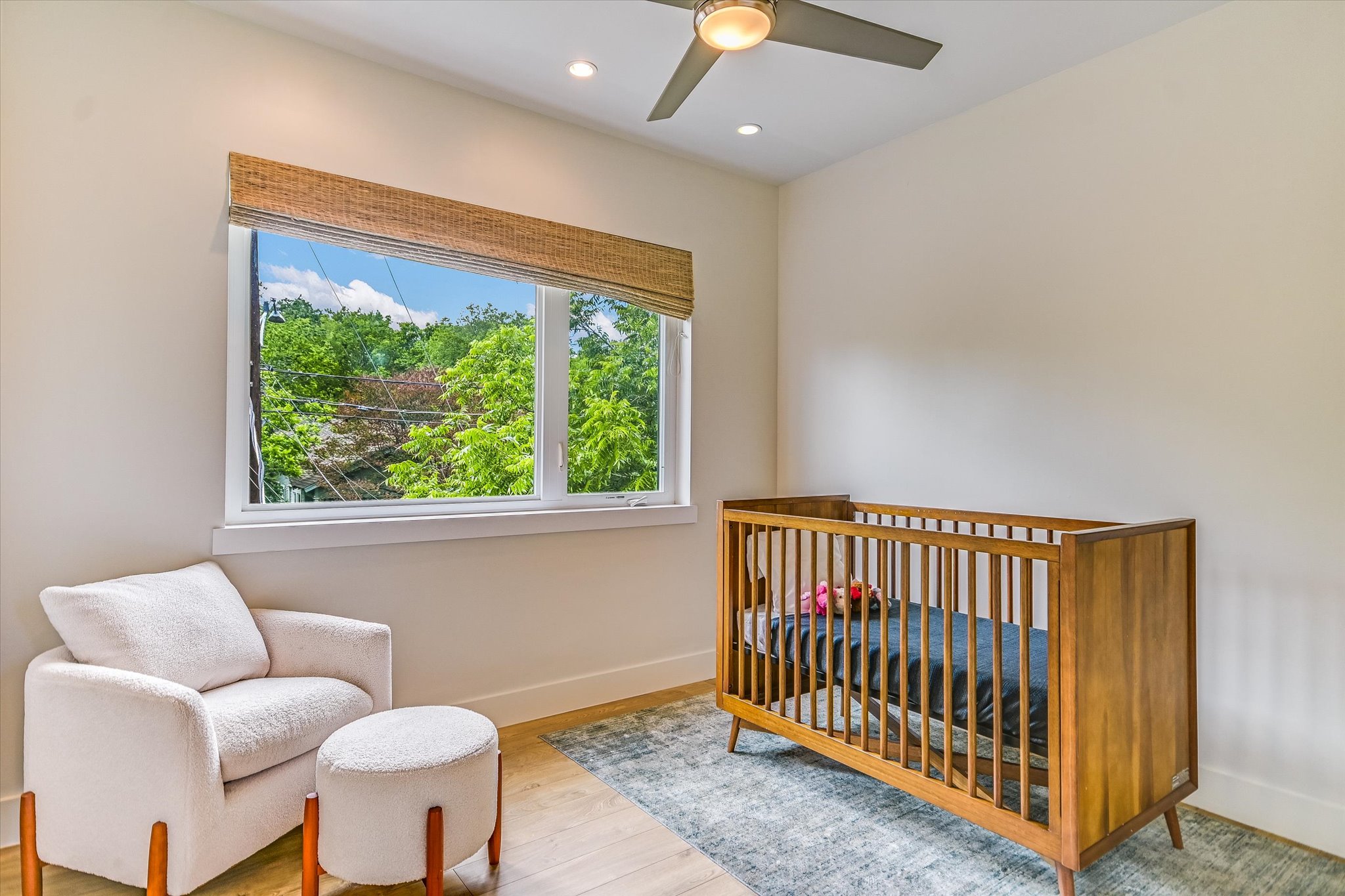 1605 Hether Street Austin, TX 78704 - Photo 19 of 26 Bright room featuring a large window, recessed lighting, a modern ceiling fan, wood-finish flooring, and light-toned walls