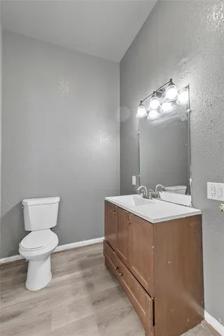 an empty room with windows and chandelier fan