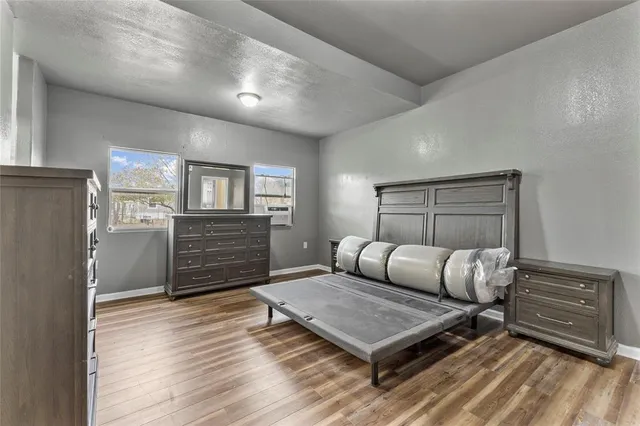 a bedroom with furniture and wooden floor