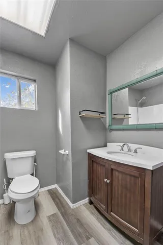 a bathroom with a toilet sink and mirror