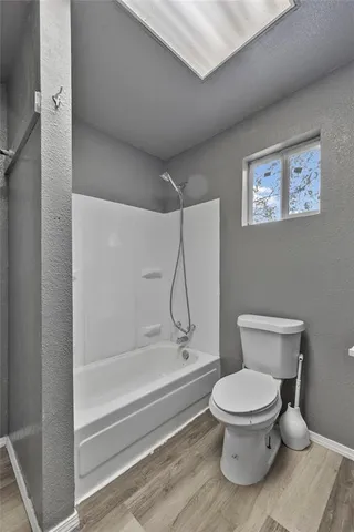 a bathroom with a toilet and a shower