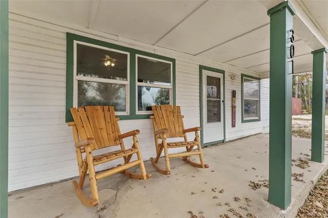 a view of two chairs in front of house