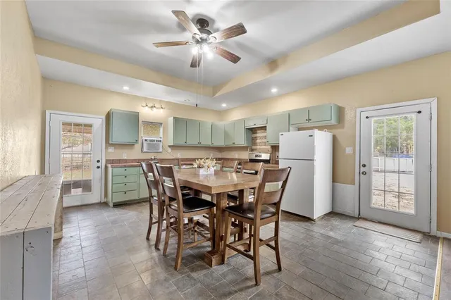 a view of a dining room with furniture and a chandelier
