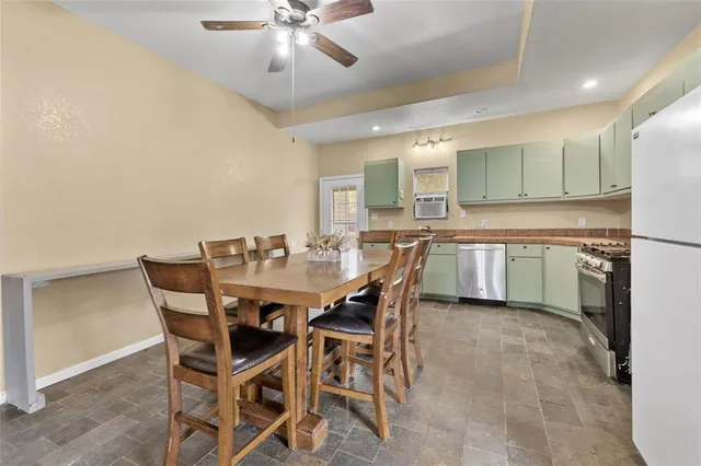 a view of a dining room and a kitchen with a dining table chairs
