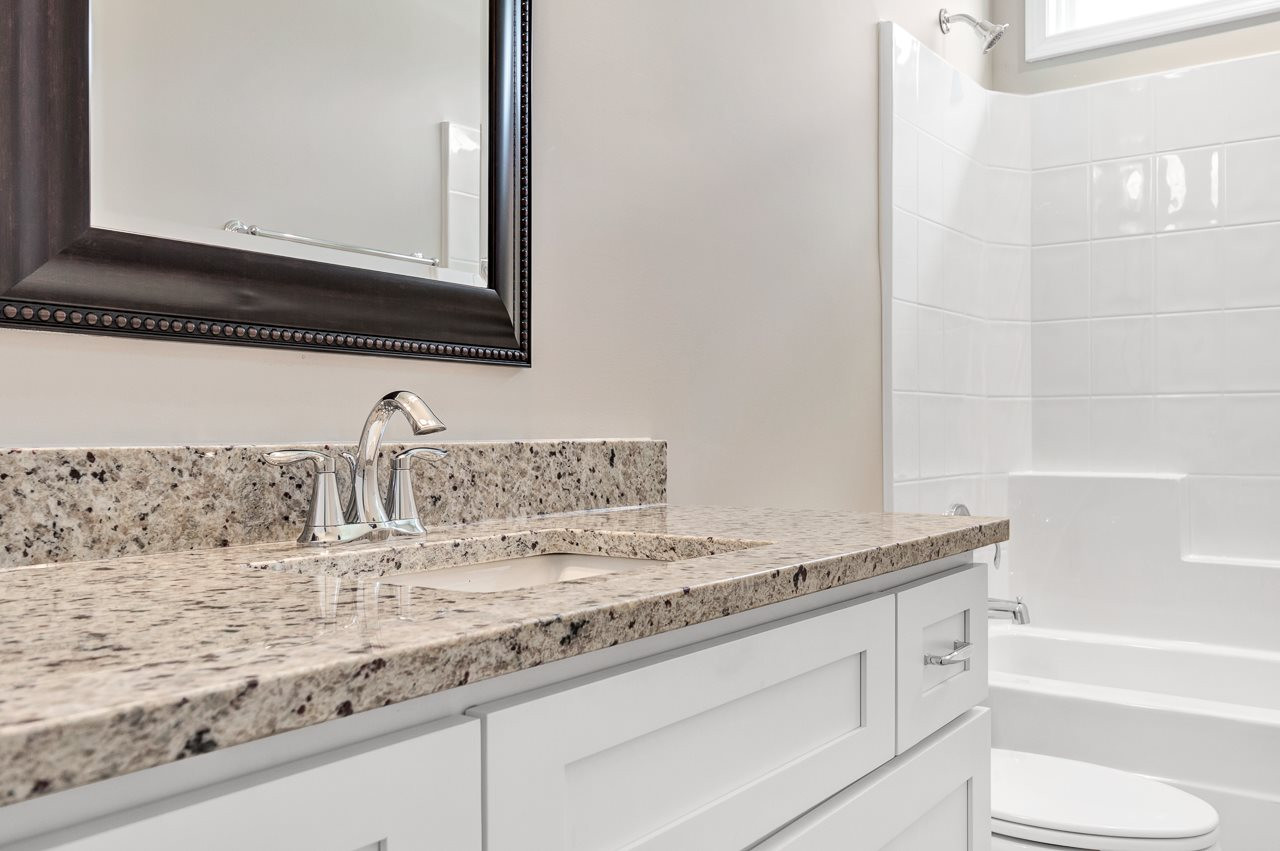 6733 Dwight Rowland Road Willow Spring, NC 27592 - Photo 13 of 25 Large cabinetry with nice updated countertops hall bath room