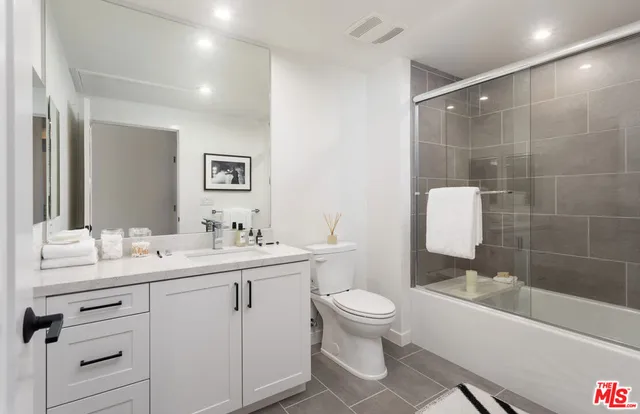 a view of a swimming pool with a table and chairs under an umbrella