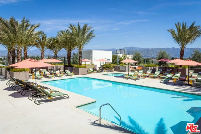 a view of a patio with swimming pool table and chairs
