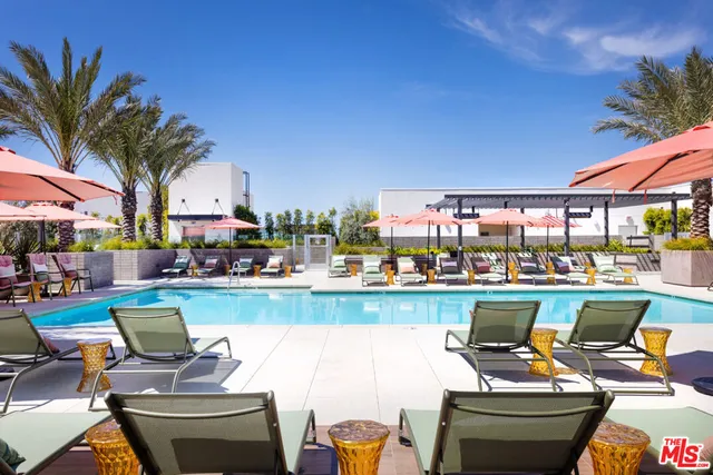 a view of a backyard with furniture and a garden