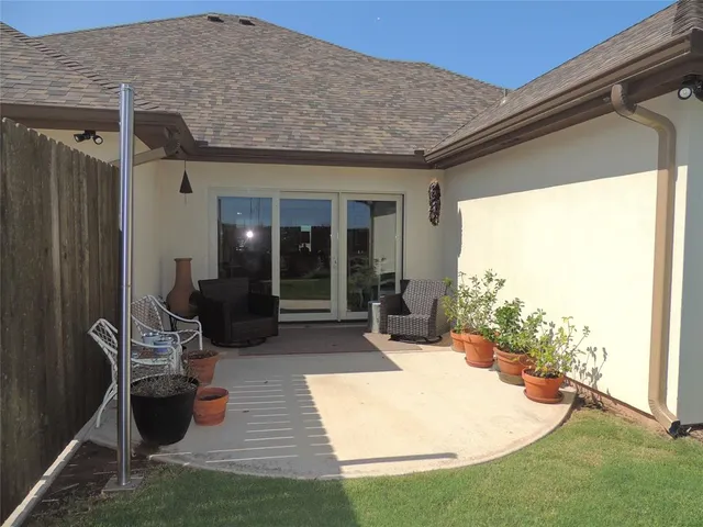 a view of a patio with chair and tables