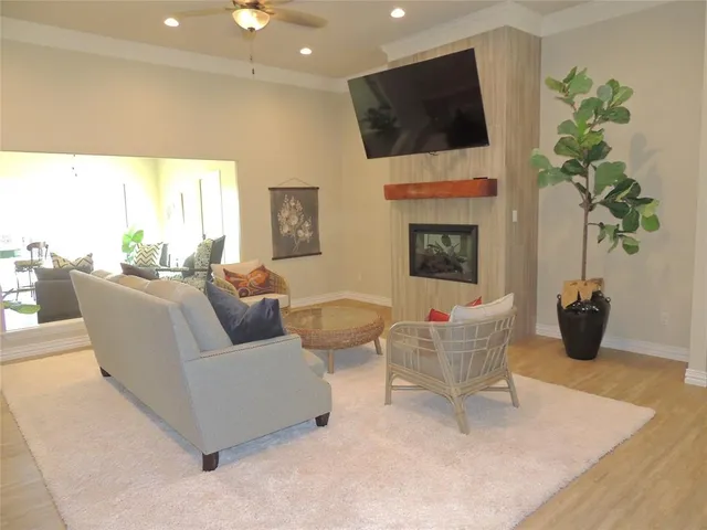 a living room with fireplace furniture and a flat screen tv