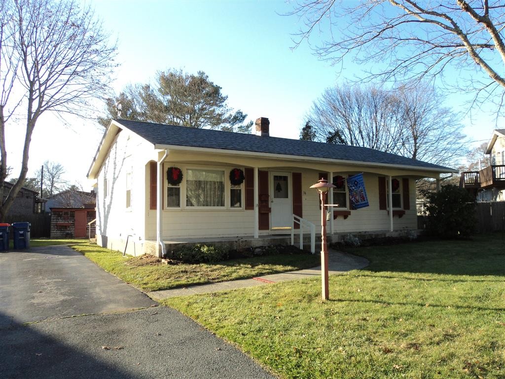 36 Longview Road New Bedford, MA 02745 - Photo 1 of 12 a house that has a tree in front of it