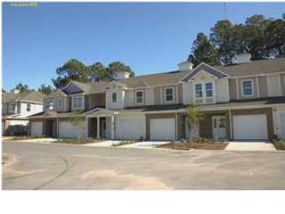 8619 Front Beach Road, Unit F2 Panama City Beach, FL 32408 - Photo 1 of 1 a front view of a house with a garden