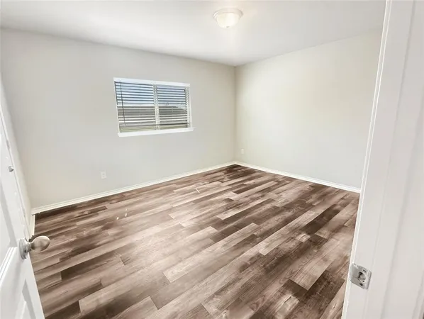 a view of a room with wooden floor