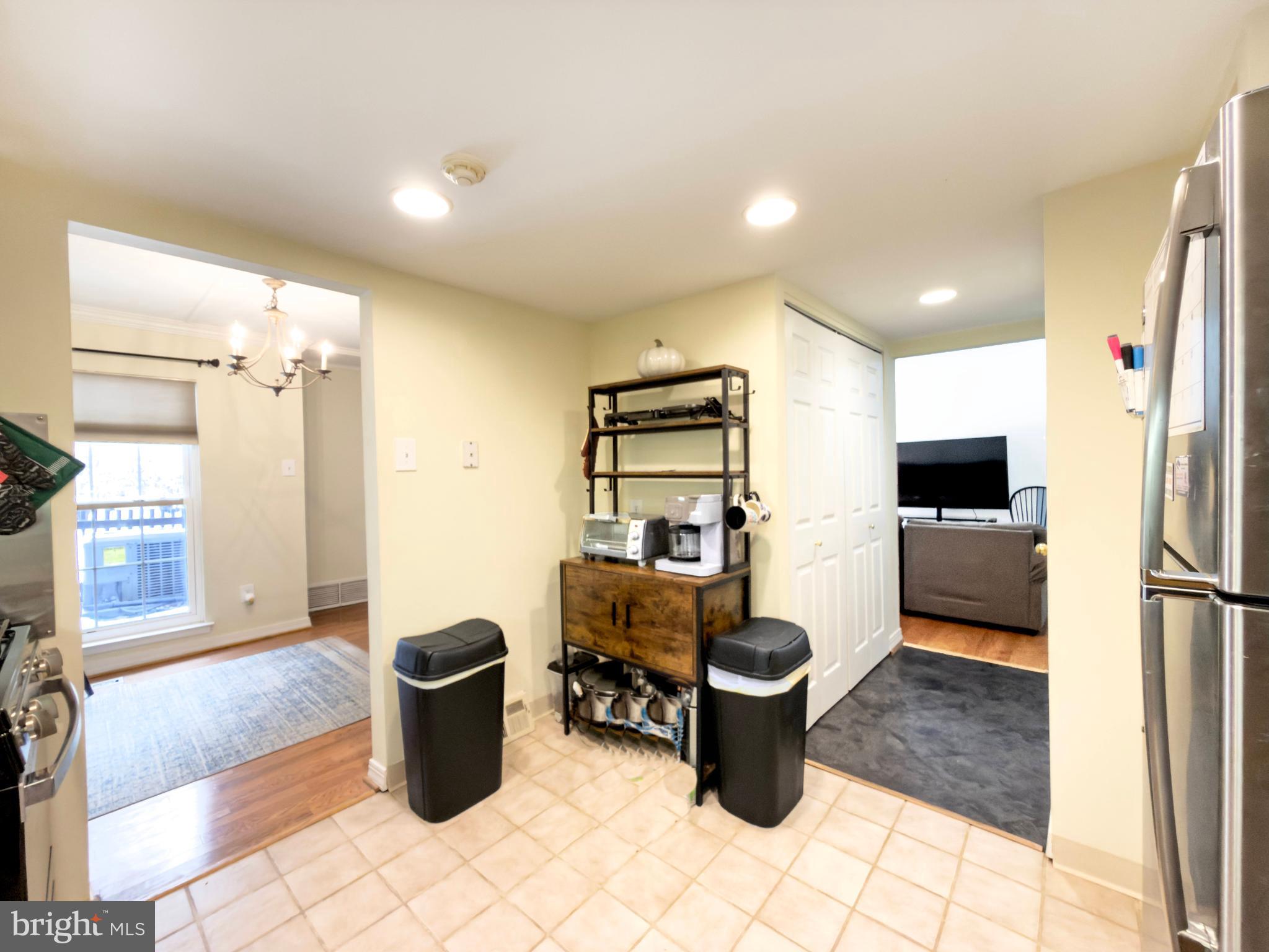 66 Old Forge Crossing, Unit 66 Devon, PA 19333 - Photo 15 of 16 a living room with furniture a flat screen tv and a refrigerator