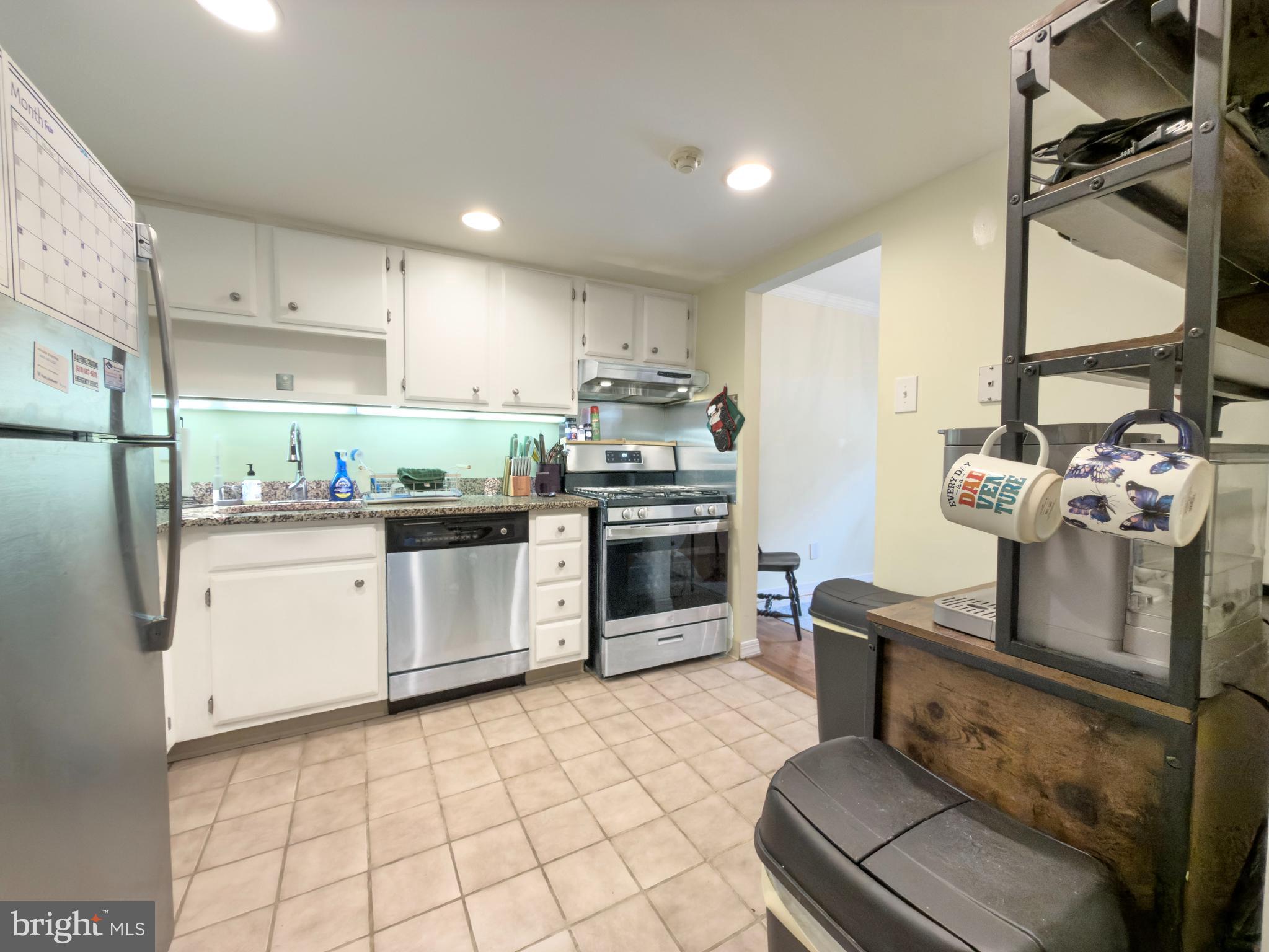 66 Old Forge Crossing, Unit 66 Devon, PA 19333 - Photo 8 of 16 a kitchen with stainless steel appliances granite countertop a stove a sink and a refrigerator