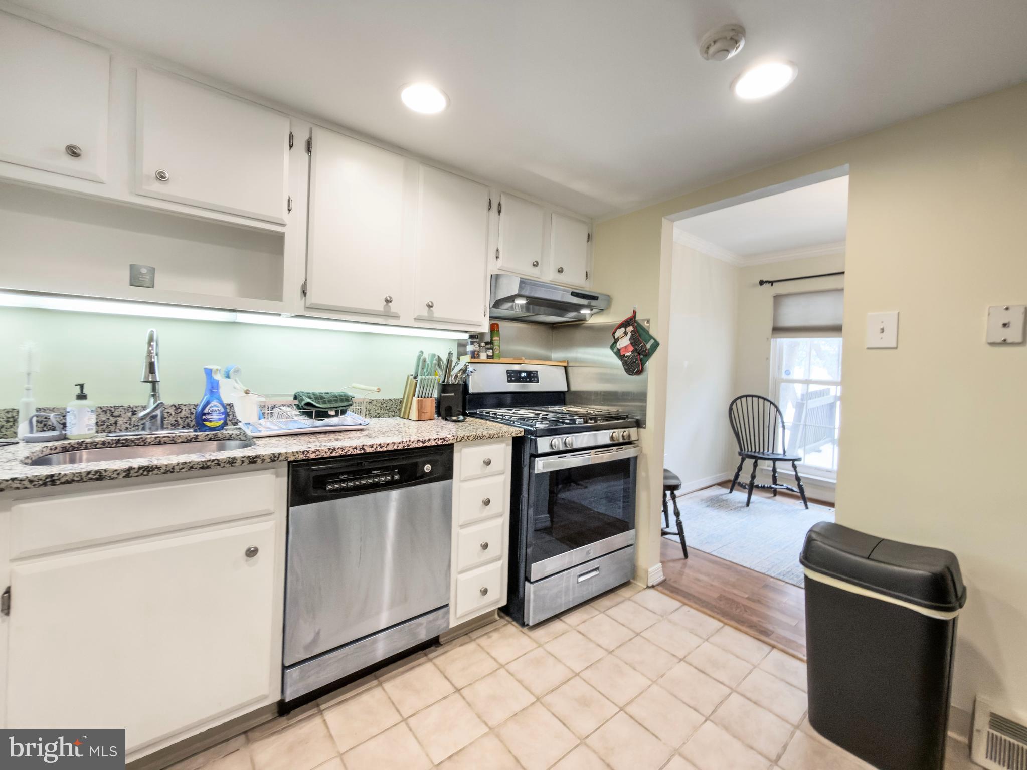 66 Old Forge Crossing, Unit 66 Devon, PA 19333 - Photo 9 of 16 a kitchen with granite countertop a sink stove and cabinets