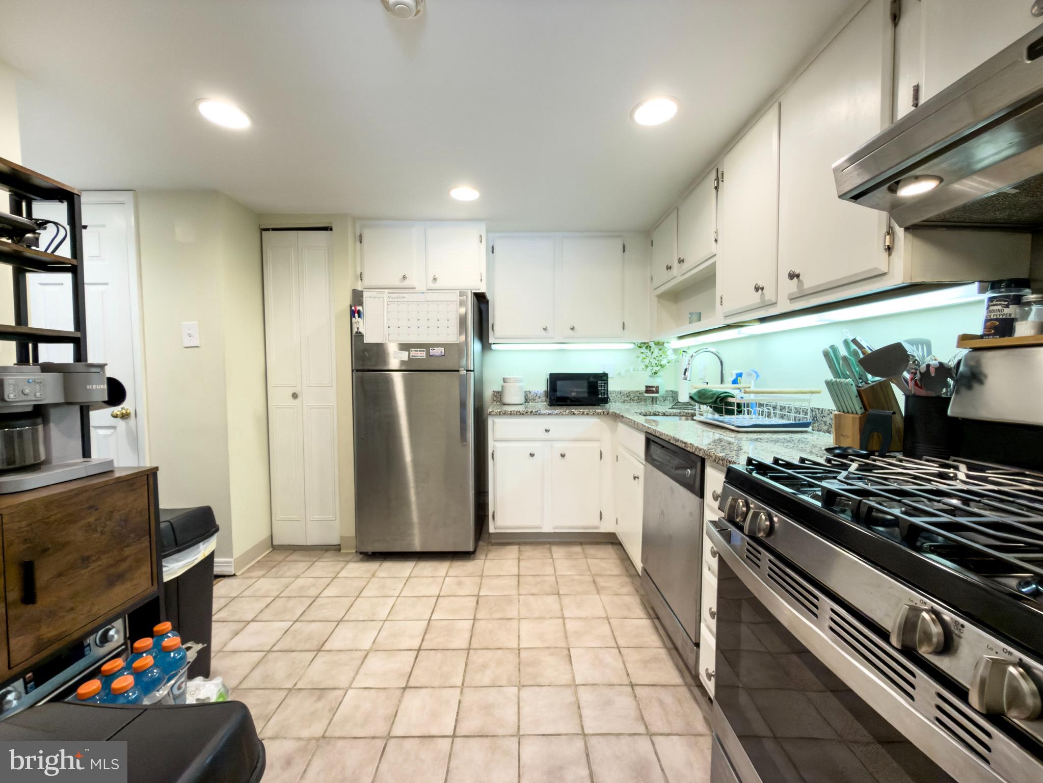 66 Old Forge Crossing, Unit 66 Devon, PA 19333 - Photo 10 of 16 a kitchen with stainless steel appliances granite countertop a stove a sink and a refrigerator