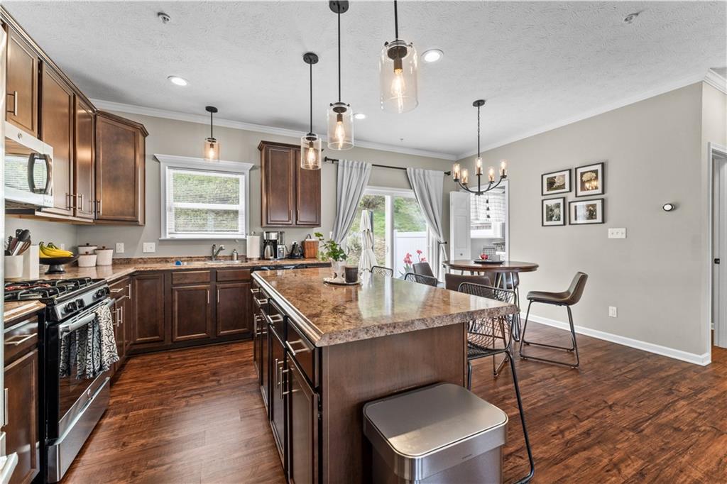 159 Rylie Drive Harmony, PA 16037 - Photo 12 of 36 a kitchen with granite countertop a sink appliances and wooden floor