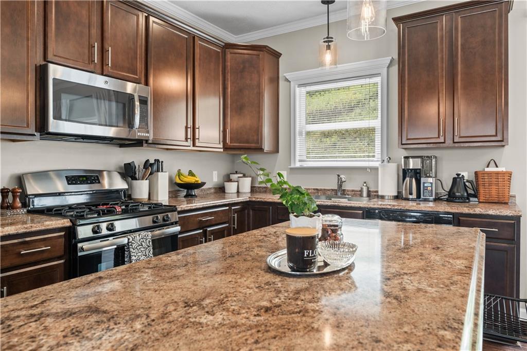 159 Rylie Drive Harmony, PA 16037 - Photo 14 of 36 a kitchen with stainless steel appliances granite countertop a sink stove and microwave