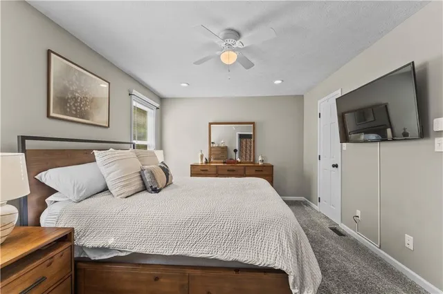 a bedroom with a large bed and a flat screen tv