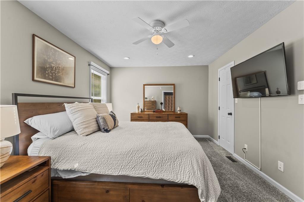 159 Rylie Drive Harmony, PA 16037 - Photo 24 of 36 a bedroom with a large bed and a flat screen tv