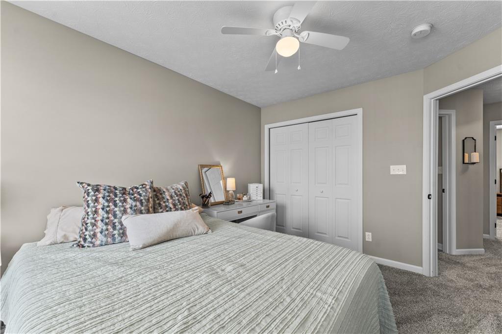 159 Rylie Drive Harmony, PA 16037 - Photo 29 of 36 a bedroom with a bed and a chandelier