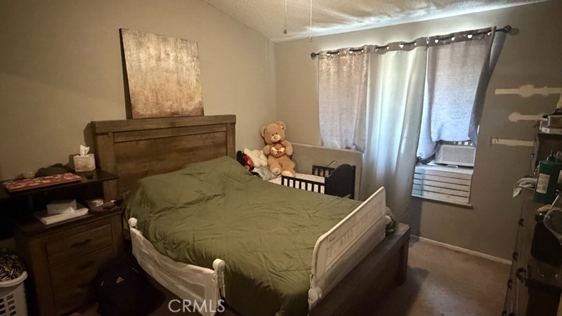 2478 KOA Drive Rialto, CA 92377 - Photo 4 of 18 a bed sitting in a bedroom next to a window and a mirror