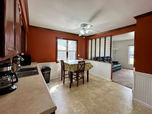 a view of a a dining room with furniture window and outside view