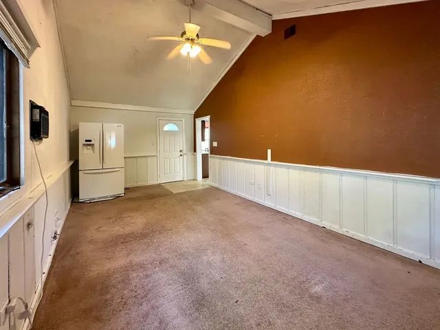 a view of a kitchen with a refrigerator and a dishwasher
