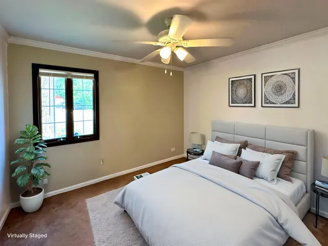 a bedroom with a bed and a potted plant