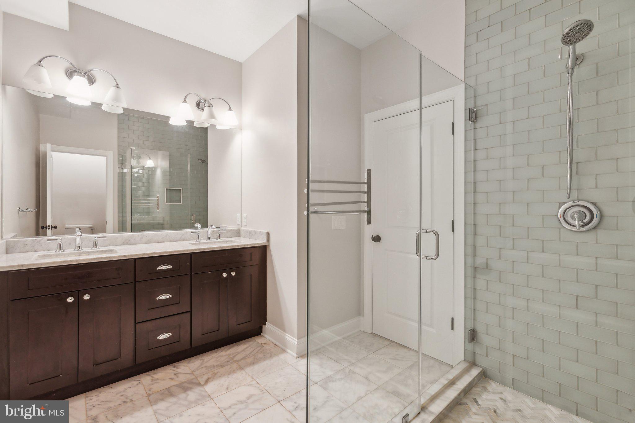 39 U Street Northeast, Unit 1 Washington, DC 20002 - Photo 10 of 22 a bathroom with a double vanity sink mirror and shower