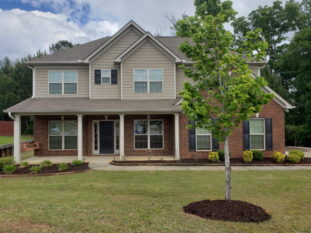 a front view of a house with a yard