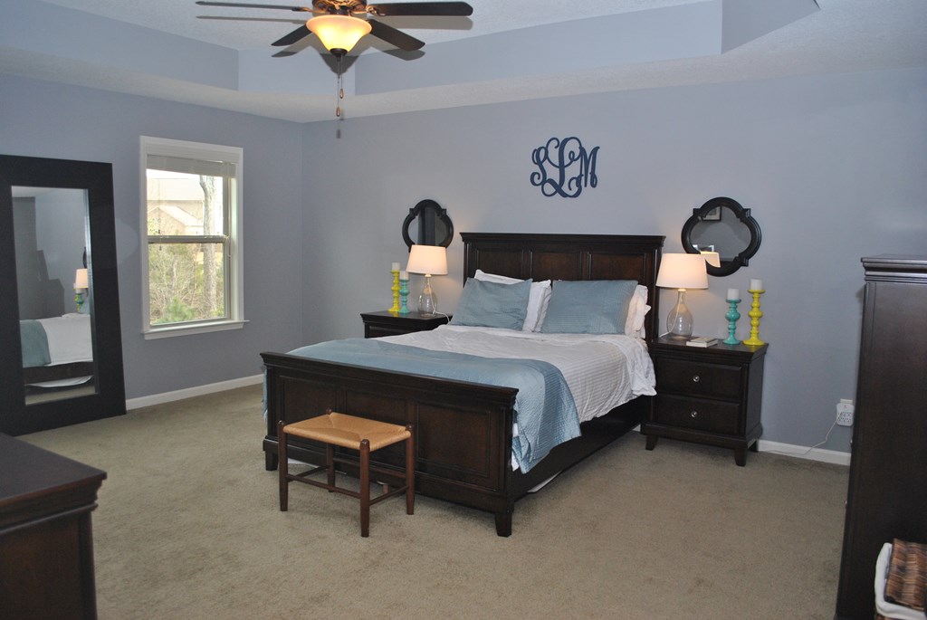 9536 English Ivy Court Fortson, GA 31808 - Photo 12 of 22 a bedroom with a bed and a chandelier