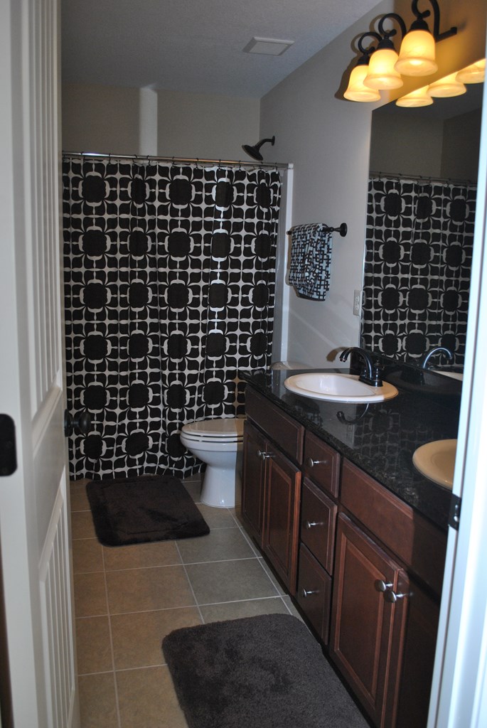 9536 English Ivy Court Fortson, GA 31808 - Photo 17 of 22 a bathroom with a sink a toilet and a shower