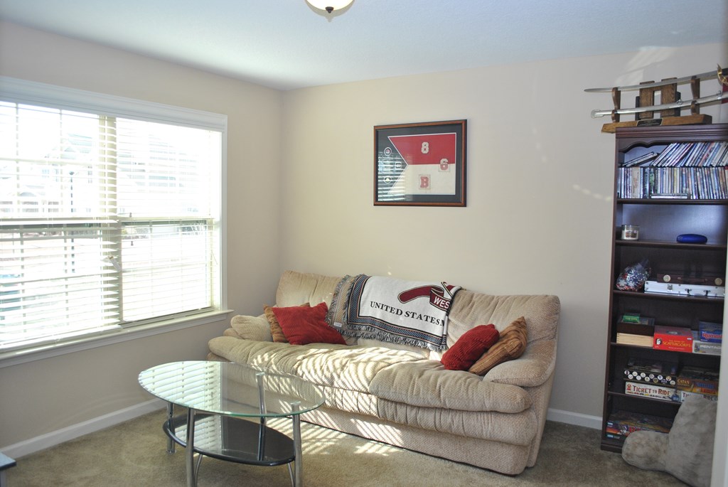 9536 English Ivy Court Fortson, GA 31808 - Photo 18 of 22 a living room with furniture a bookshelf and a window
