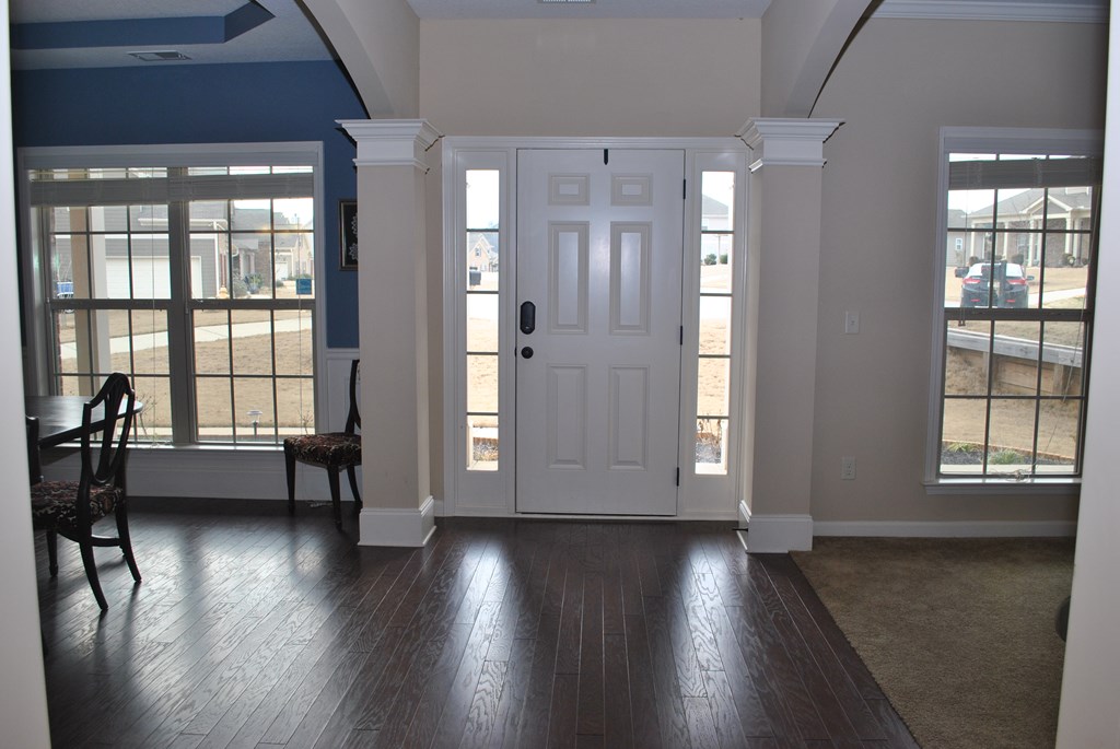 9536 English Ivy Court Fortson, GA 31808 - Photo 2 of 22 an empty room with wooden floor and windows with curtains