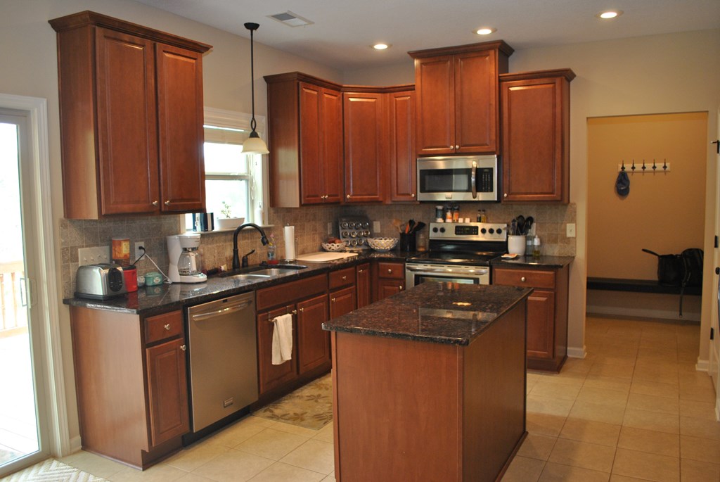 9536 English Ivy Court Fortson, GA 31808 - Photo 5 of 22 a kitchen with stainless steel appliances granite countertop a stove a sink and a microwave